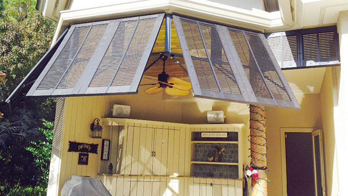 AFTER: With the help of his sons, Michael Brock installed new Bermuda shutters to give his outdoor space an upscale coastal feel.