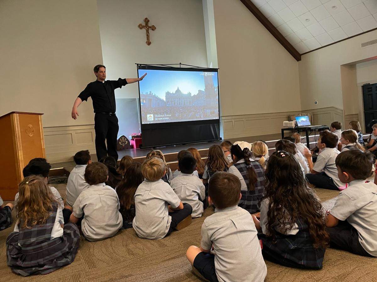 Father Andrew Trapp and students at St. Peter’s Catholic Church on Lady’s Island watch a live feed from Vatican City Thursday when a new pope was chosen.
