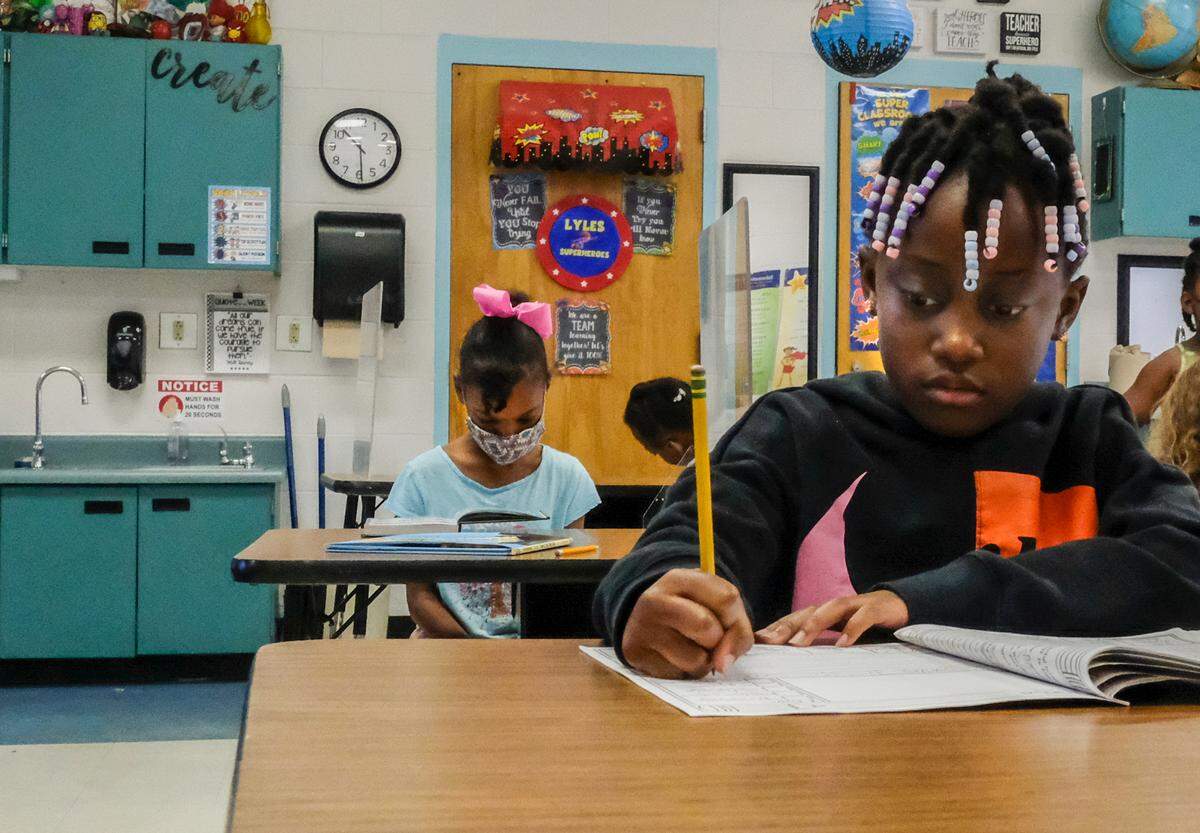 Attending second grade next year, Deonna Green, front, works on problems as Sophia Holmes, back, reads one of her favorite books on Thursday, July 29, 2021 on the last day of summer school at Coosa Elementary School on Lady’s Island.