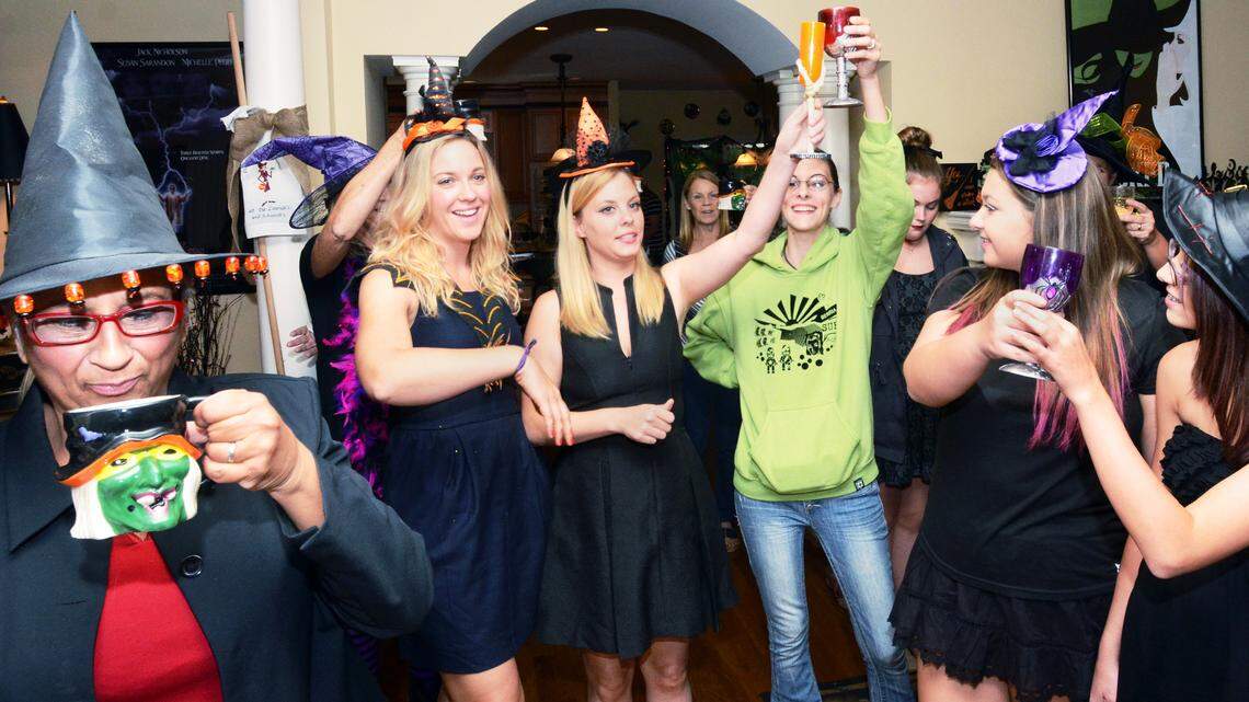 Attendees share a toast at the "witches' call" at the start of the 10th annual Witch and Bitch party at the home of Debbie Laurich and Connie Schwerdt on Saturday. At the party some 50 women dressed as witches gathered to socialize and compete in a witch doll-making contest.