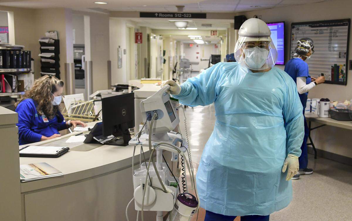 April Simmons-Smith, RN, models the full personal protective equipment that medical staff wear before going into a patient’s room on April 16, 2020 at Beaufort Memorial Hospital. Some of the equipment that is worn is doubled. Two sets of gloves are worn which allows staff to wipe down equipment after the outer gloves are removed, after using hand sanitizer. Other doubled equipment includes face masks. A disposable face mask is worn over the invaluable N95 face mask to increase their longevity.