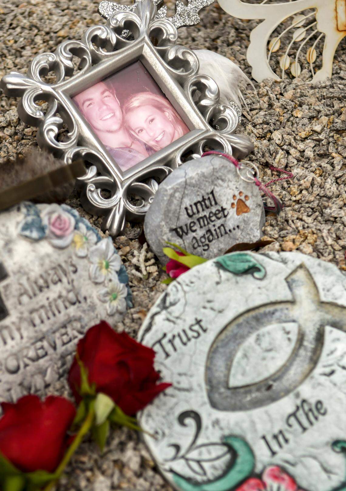 Pictured is a framed photo of Mallory Beach with her boyfriend, Anthony Cook, memorial stones and red roses set out for Valentines Day as seen at her gravesite on Friday, Feb. 21, 2020 in Sandy Run Cemetery near Varnville in Hampton County, South Carolina. Beach, 19, was killed in a boat accident in Archers Creek in Beaufort County on Feb. 24, 2020 when the boat she was in struck a bridge piling.