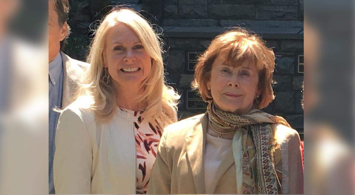 Lise Dixon (left) and her mother, Jaquey Schmid (right) smile for a photograph.