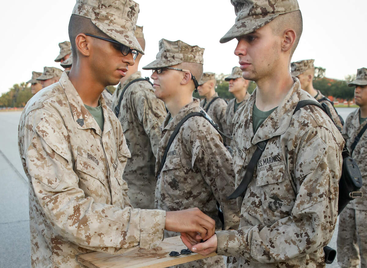Recruit James McConnell, with Lima Company, 3rd Recruit Training Battalion, receives the Eagle, Globe, and Anchor after completing The Crucible on Sept. 22 at the Marine Corps Recruit Depot Parris Island.