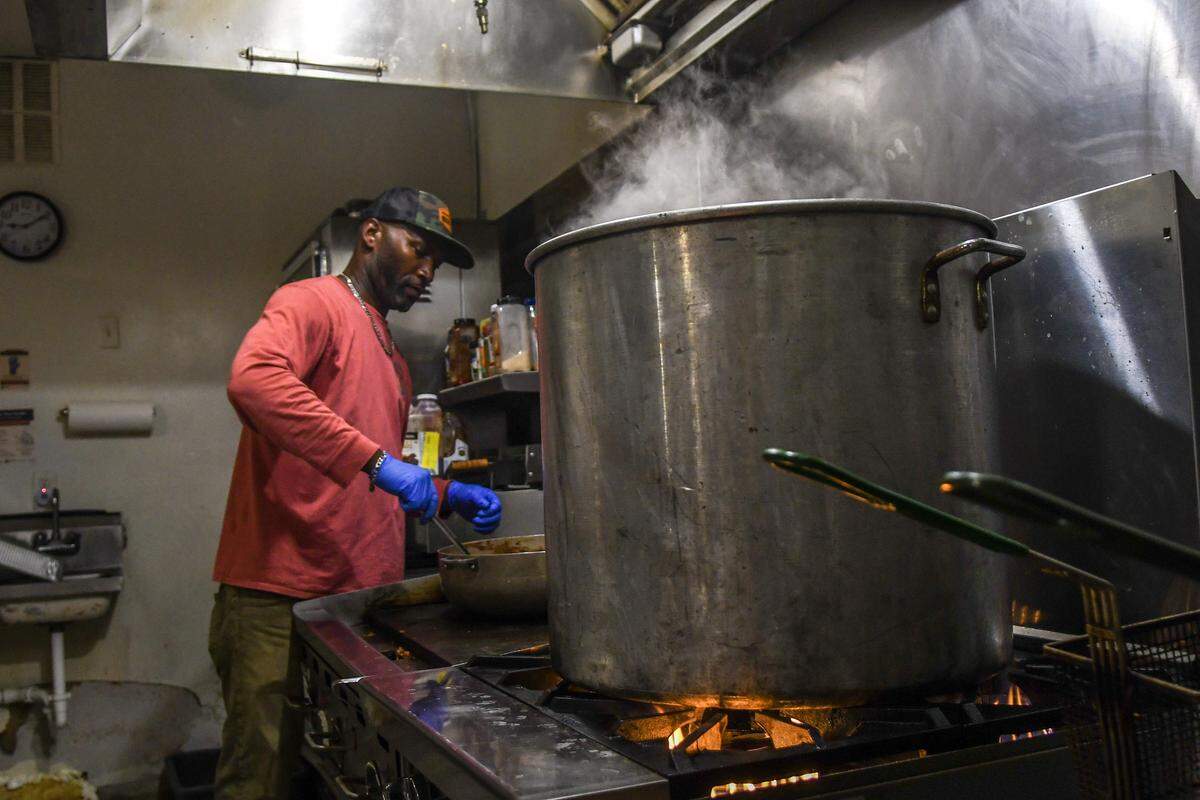 Lamont Greenwood with Her Table Catering & Events stirs the roux on Oct. 14, 2025, as the chicken, sausage, and okra gumbo cooks on the stove in the kitchen of Willie’s Bar and Grill on St. Helena Island. Starting today through Friday, the caterer will sell plates of food for $20 with 100 percent of the proceeds benefiting the victims of the early Sunday morning mass shooting that killed four and injured scores of others.