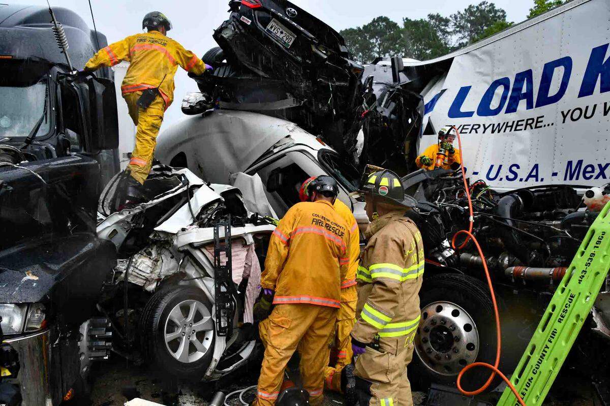First responders were pictured climbing through the wreckage after a deadly pileup on I-95 the afternoon of July 22, 2025 near Yemassee. Two people died in the crash, which happened as heavy thunderstorms swept through the Lowcountry that afternoon. Witnesses reported blinding rains and near-zero visibility on the interstate.