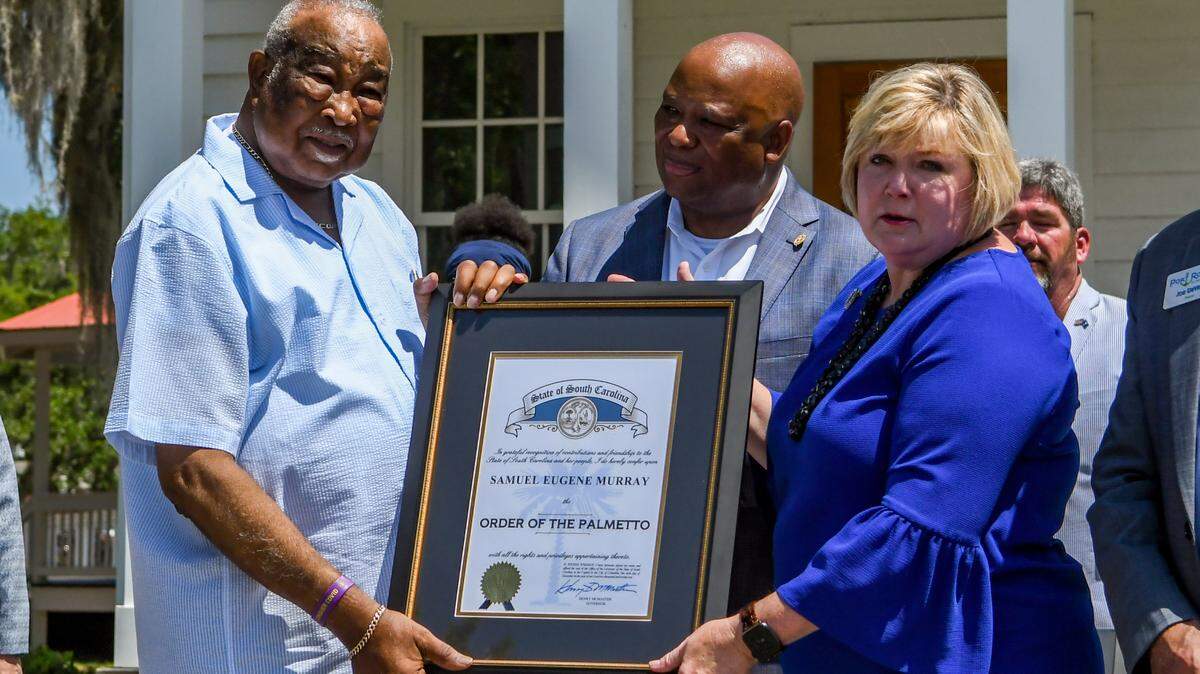 In a surprise announcement on Friday, June 10, 2022, state Rep. Shannon Erickson, right, and state Sen. Gerald Malloy, center, present former Town of Port Royal Mayor Sam Murray with the state’s highest honor, the Order of the Palmetto. Murray retired in 2019 after 41 years of public service, first as a councilman and then as mayor since 1995.