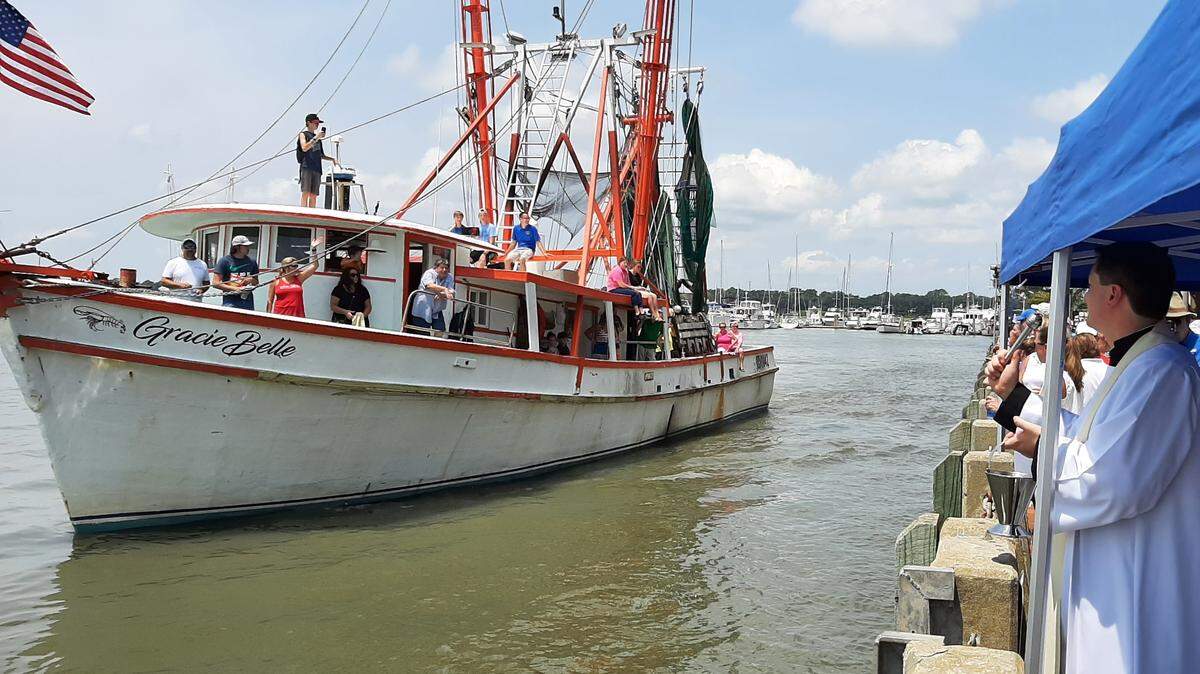 Rev. Andrew Trapp of St. Peter’s Catholic Church blesses the shrimp boat Gracie Belle on Sunday, July 25, 2021, the final day of the Beaufort Water Festival.