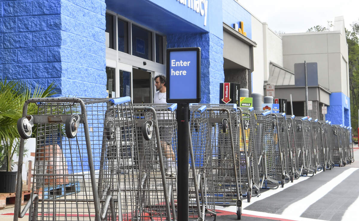 Overturned shopping carts direct customers to the correct door at the Walmart in New River Crossing on Wednesday, April 8, 2020, in Hardeeville. On Monday, S.C. Governor Henry McMaster placed an executive order that essential businesses must limit the number of customers based on the square footage of their facility or 20% of the occupancy, whichever is less, in hopes of stemming the spread of the coronavirus.