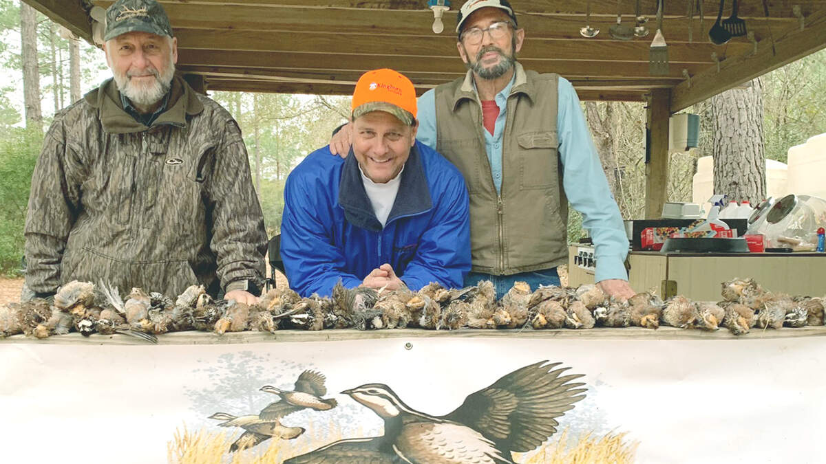 Al Stokes, Grant Kaple and Collins Doughtie show off their quail-hunting bounty.