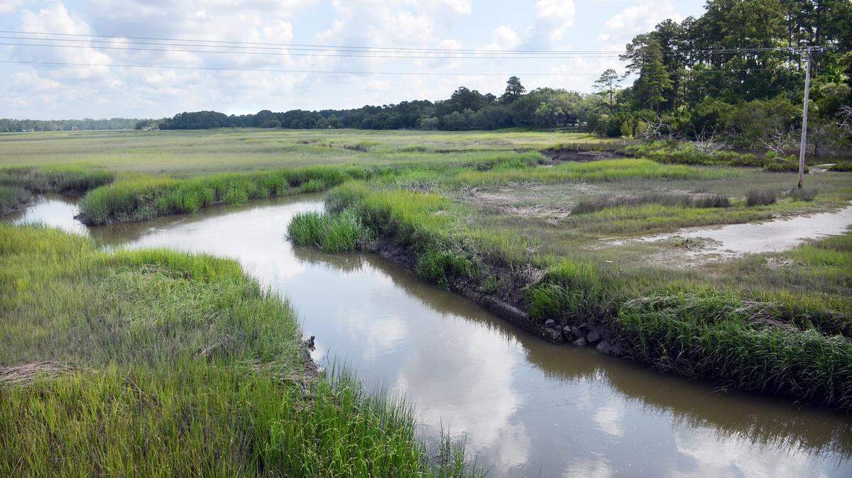 File: The Okatie River flows past the Pepper Hall tract, at right, in this June 8, 2015, view from the U.S. 278 bridge.