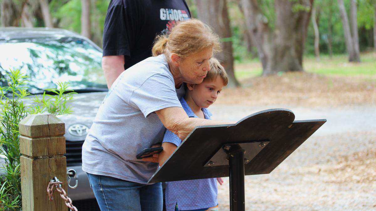 Hilton Head resident Tami Krivit shows her grandson Mason the inscription beside the statue of Harriet Tubman at Historic Mitchelville Freedom Park on April 23, 2025.