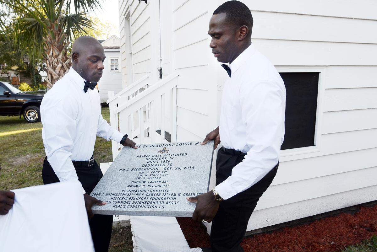 Daniel Anderson, left, and Gabriel Potter, members of the Sons of Beaufort Lodge No. 36, the African-American Masonic group to which Robert Smalls belonged, prepare to place a cornerstone for the restored lodge in Beaufort.