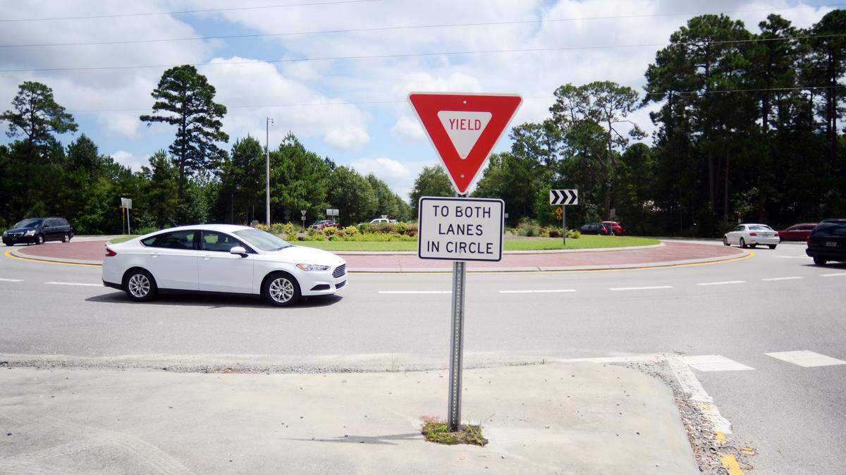 Vehicles whirl around the Bluffton Parkway traffic circle at its intersection with Bluffton Road on Monday. The traffic circle was originally installed in 2006 and it's been a headache for Bluffton drivers ever since.