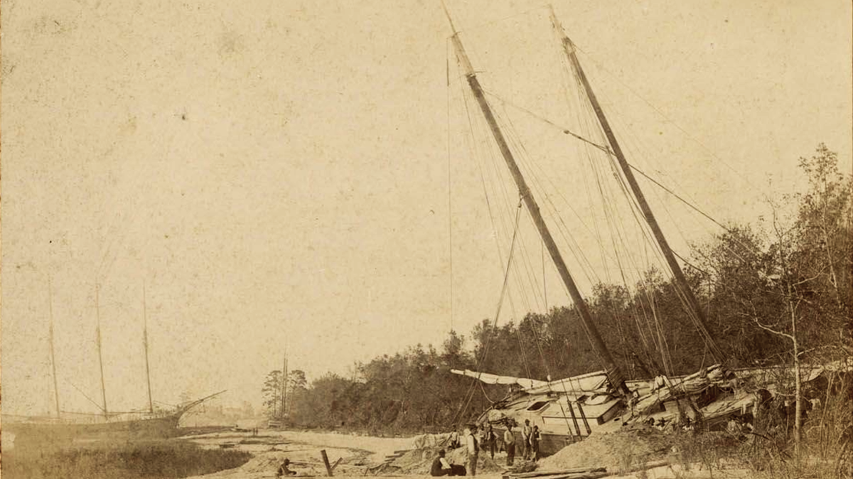 Photograph of a two-masted ship run aground near Beaufort, S.C. in August 1893. The devastating hurricane struck at a time where disasters were difficult to predict, and federal disaster relief was not the norm.