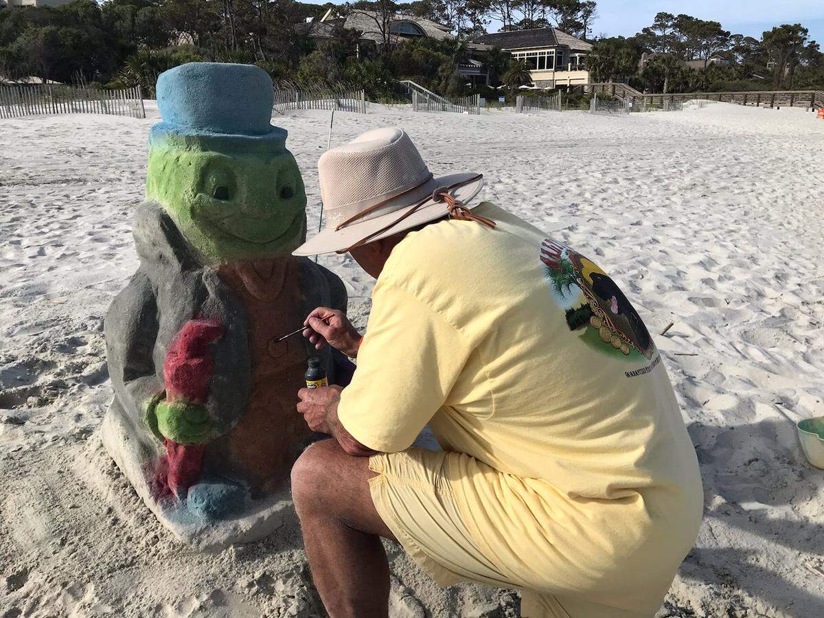 Doug Heatherington creates a sand sculpture on the Sea Pines beach on Hilton Head Island. In April 2021, he was fined $1,087.50 for leaving his sand sculptures up overnight.