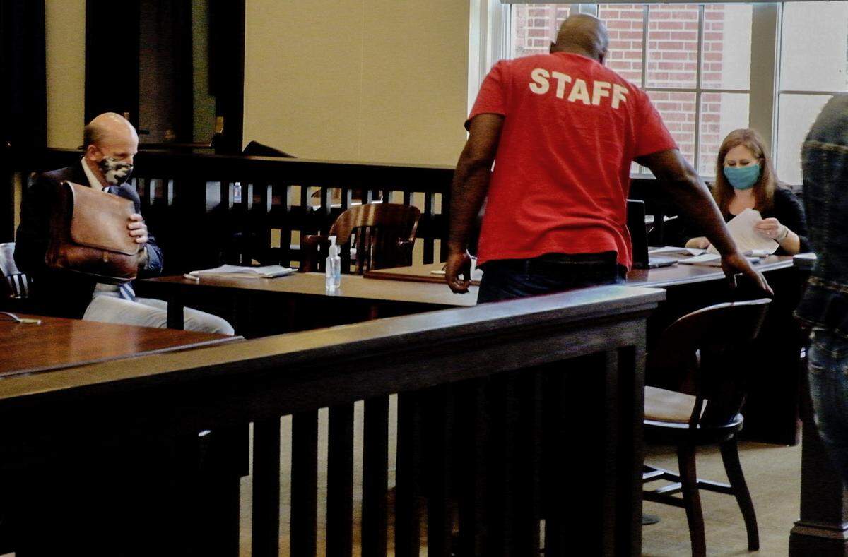 Brigette B. Autry, seated at right, a hearing officer for the S.C. Administrative Law Court/Office of Motor Vehicles Hearings informs Trevor Heyward, standing, that the results of this Friday, April 9, 2021 hearing at the Jasper County Courthouse will be made available by email in the coming days as Heyward’s attorney, Scott Lee, left, gathers his paperwork. After more than four years without a drivers license after being declared a habitual offender, Heyward asked for this hearing to have his drivers license reinstated months earlier.