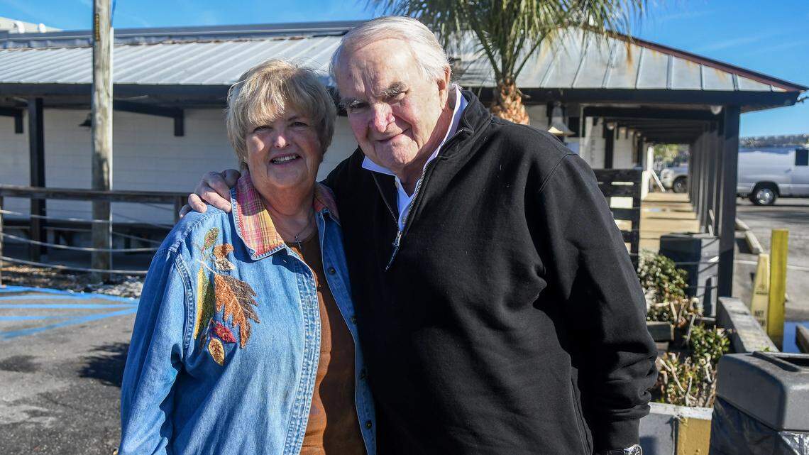 For 27 years Gloria LaCoe, left, and her husband Allan LaCoe, have helped run the annual Community Thanksgiving Dinner through their church, St. Andrew By-The-Sea United Methodist Church in partnership with Hudson’s Seafood House on the Docks. The couple, photographed at Hudson’s on Nov. 24, 2025, have decided to pass the baton on to another church member while continuing to volunteer in simpler ways.