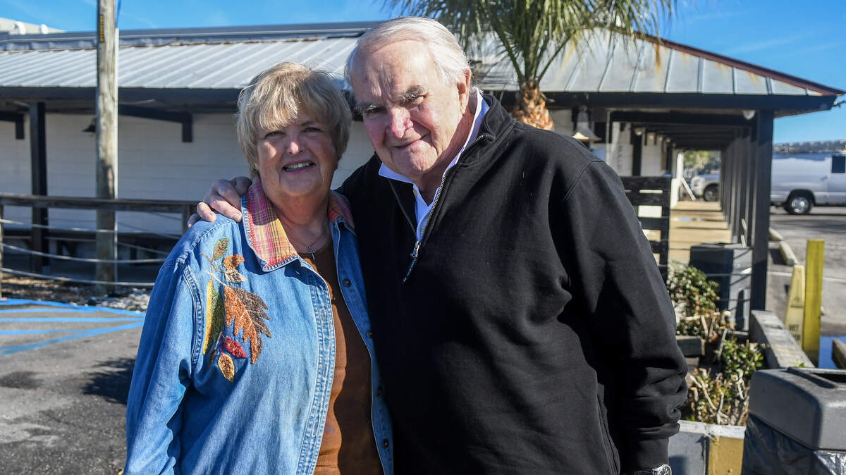 For 27 years Gloria LaCoe, left, and her husband Allan LaCoe, have helped run the annual Community Thanksgiving Dinner through their church, St. Andrew By-The-Sea United Methodist Church in partnership with Hudson’s Seafood House on the Docks. The couple, photographed at Hudson’s on Nov. 24, 2025, have decided to pass the baton on to another church member while continuing to volunteer in simpler ways.