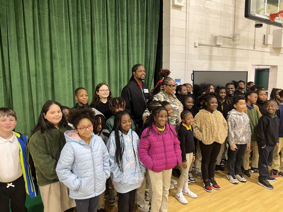 “America’s Got Talent” winner Landau Eugene Murphy Jr. and Gwen Yvette McKinnon, a singer from St. Helena, pose with St. Helena Elementary students Friday.