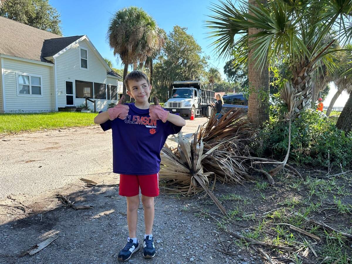 “I did not like that hurricane,” said 8-year-old Harrison McKenzie as he helped pick up nearby palmetto fronds along Alljoy Road and at the “Chisholm Cottage,” some of which were larger than himself.