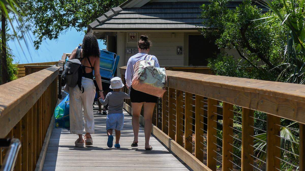 A family makes their way down the new boardwalk at Folly Field Beach Park before the start of the Memorial Day weekend on Thursday, May 23, 2024 on Hilton Head Island.