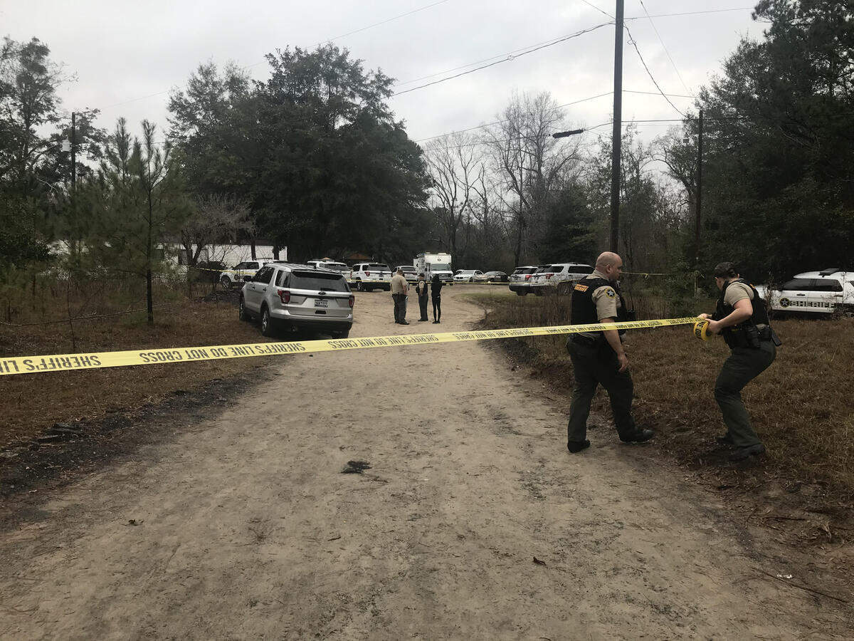 Beaufort County Sheriff’s Office deputies put up crime scene tape during the investigation of a shooting at a Burton home on Dec. 30, 2019.