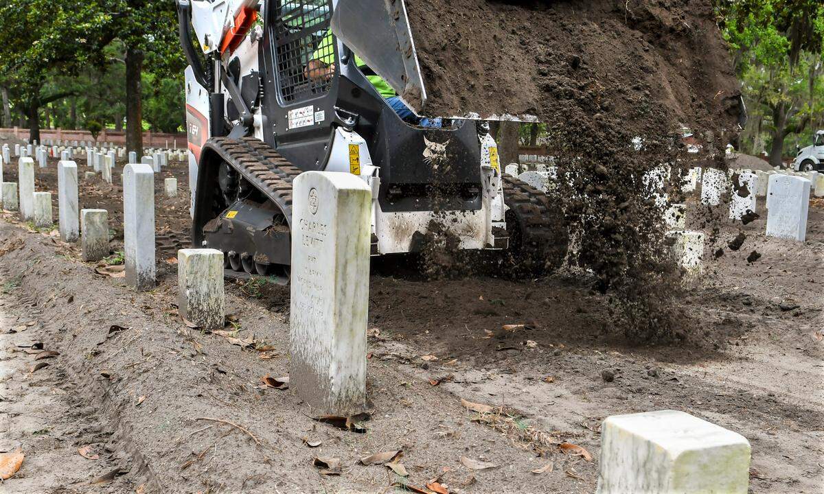 After removing the top layer of top soil, Goldsboro, North Carolina-based Landscape Design worker Raymond Ingram, operating the front-end loader, applies new top soil on Wednesday, May 25, 2022, at Beaufort National Cemetery. The cemetery will then plant zoysia sod, a hardier and more resilient grass than the original centipede turf.