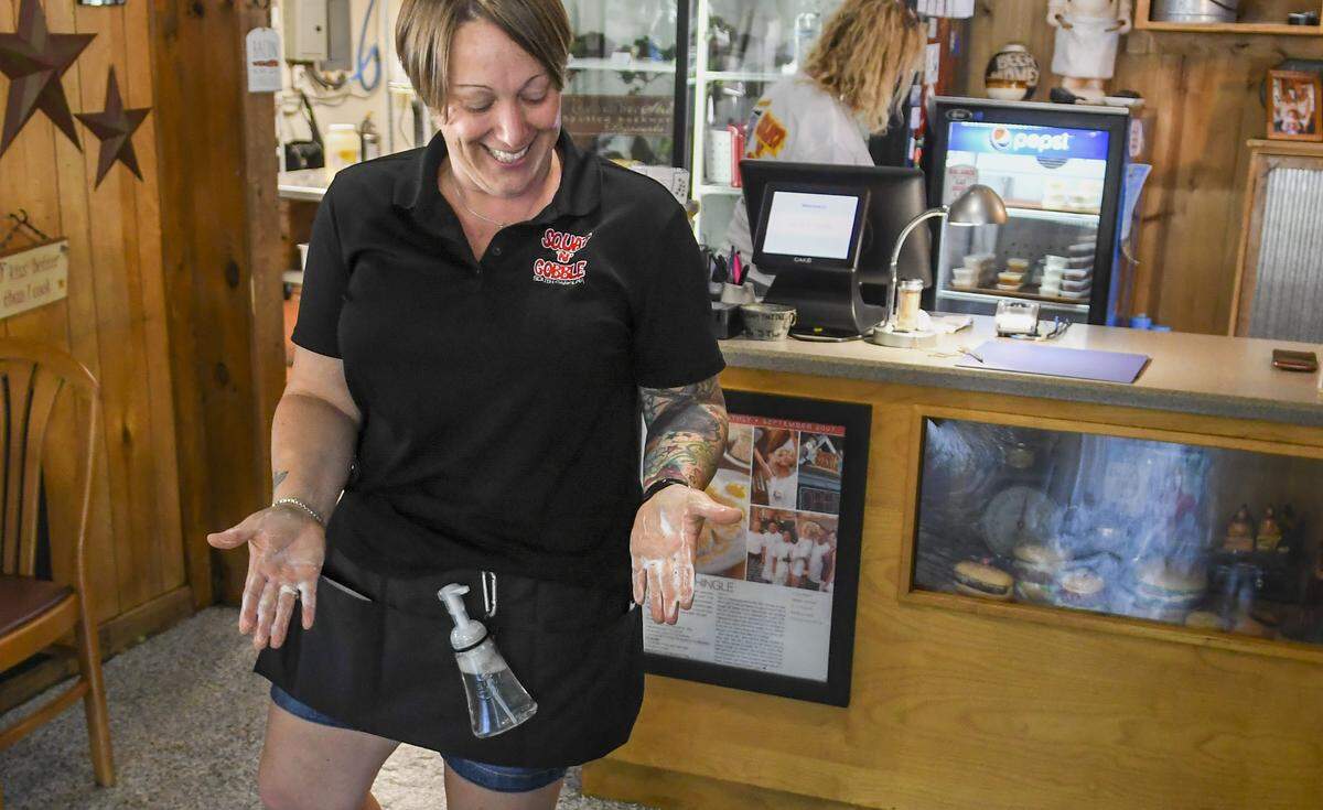 Star Wozniak, manager of Squat ’N’ Gobble displays her self made, portable hand sanitizer on Monday, May 11, 2020 in Bluffton. Monday marked the first day restaurants could have indoor seating at half the capacity after SC Governor Henry McMaster relaxed some of the rules on closures he enacted to stop the spread of the coronavirus. Wozniak said most of her customers ate outside but can’t answer why. ”Is it because it’s beautiful outside or they’re afraid to come inside?” she asked with a shrug.