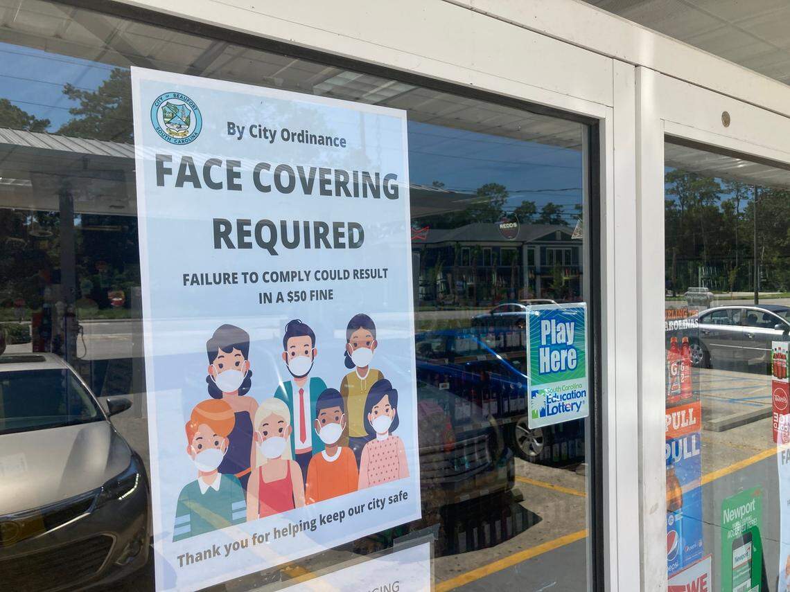 A sign in the door of a convenience store on Ribaut Road tells customers face masks are required as part of city of Beaufort rules enacted July 1 to slow the spread of COVID-19.