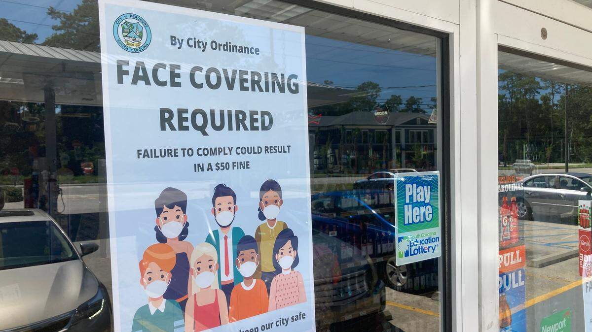 A sign in the door of a convenience store on Ribaut Road tells customers face masks are required as part of city of Beaufort rules enacted July 1 to slow the spread of COVID-19.