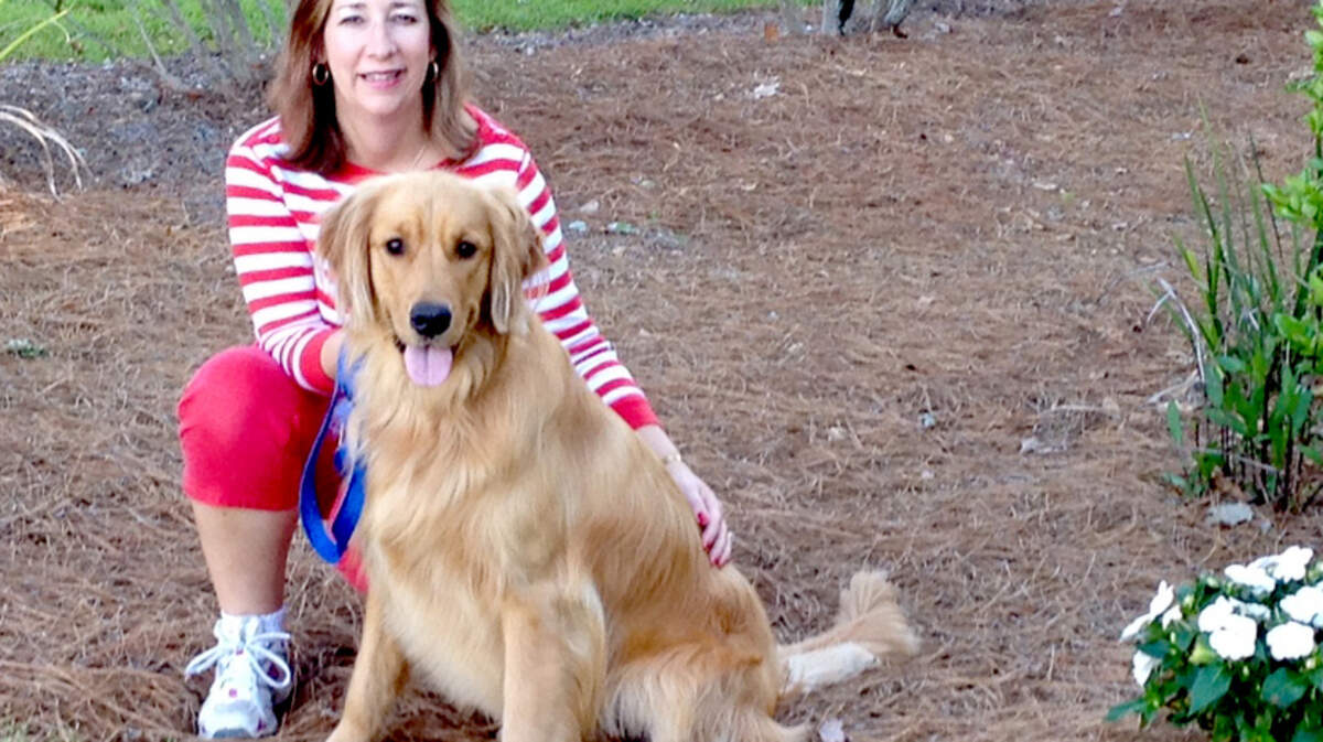 Cheryl Raugh with her golden retriever Boone.