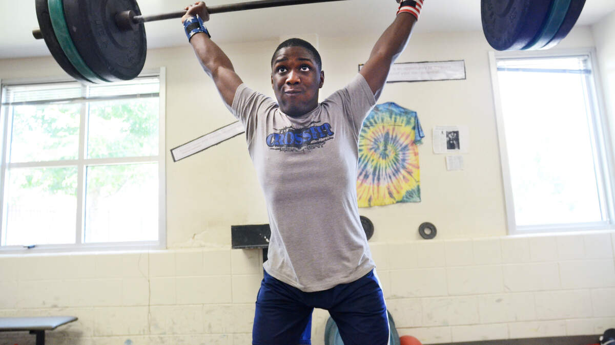 Star 13-year-old weightlifter C.J. Cummings push presses 200 pounds as he practices up on Wednesday for his upcoming appearance at the USA Weightlifting Youth Nationals in Daytona Beach, Fla.