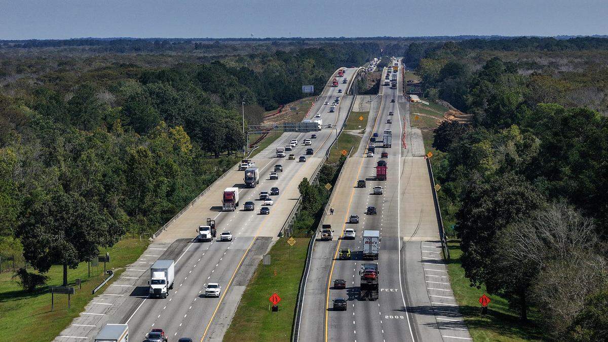 This 2025 drone photo of Interstate 95 shows traffic heading north, right, as drivers leaving Georgia must merge to two lanes as they enter into South Carolina. The state of South Carolina is currently widening I-95 to three lanes, including building a new bridge over the Savannah River.