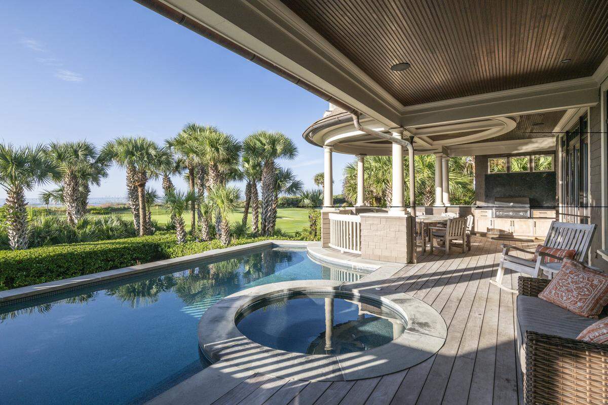 Designed by architect Zach Carney, the home blends traditional Lowcountry architecture with refined luxury, with bluestone accents framing the front and rear staircases, porches and pool surround.