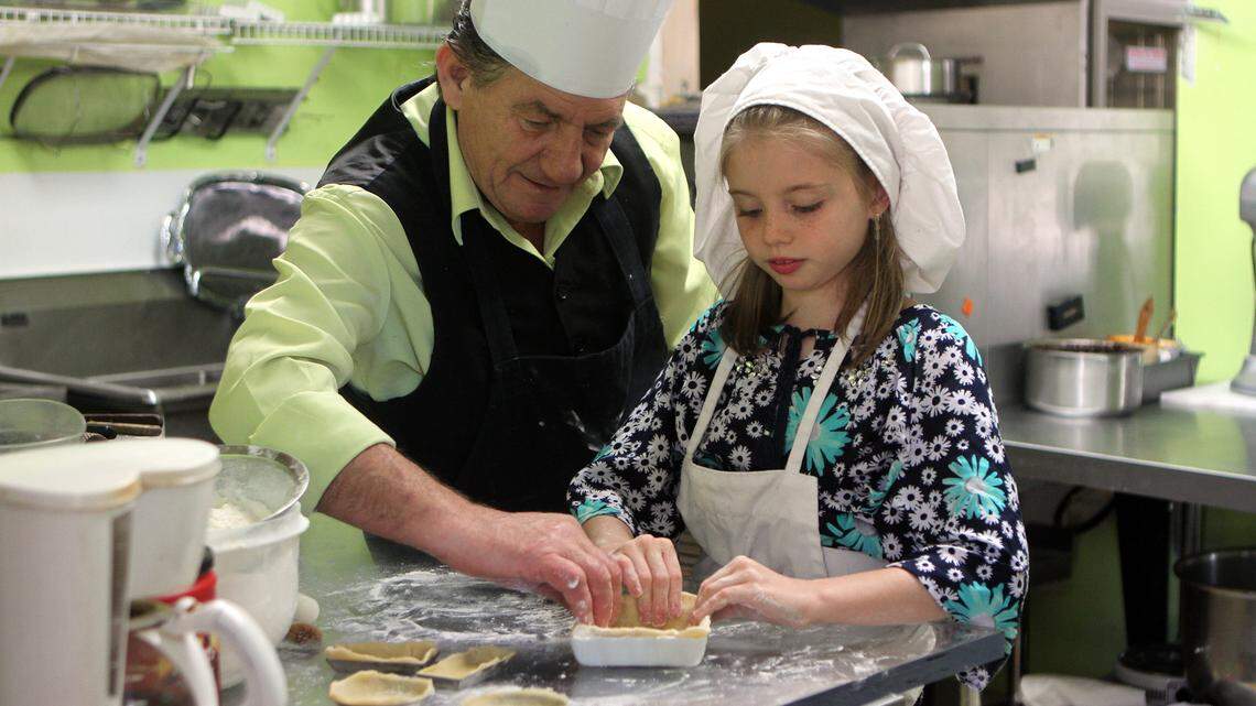 Midnight Bakers owner Robert Plantadis and Olivia Renaud, 9, of Bluffton form a tart pastry shell together on Sunday morning at the bakery in Bluffton.  Plantadis is been teaching Renaud how to make pastries and other baked goods because she wants to learn.