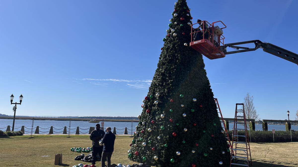 City workers decorate the 40-foot-tall Christmas Tree in Beaufort Waterfront Park last week. The city is launching its holiday shopping season Friday with discounted shopping tickets and free parking.