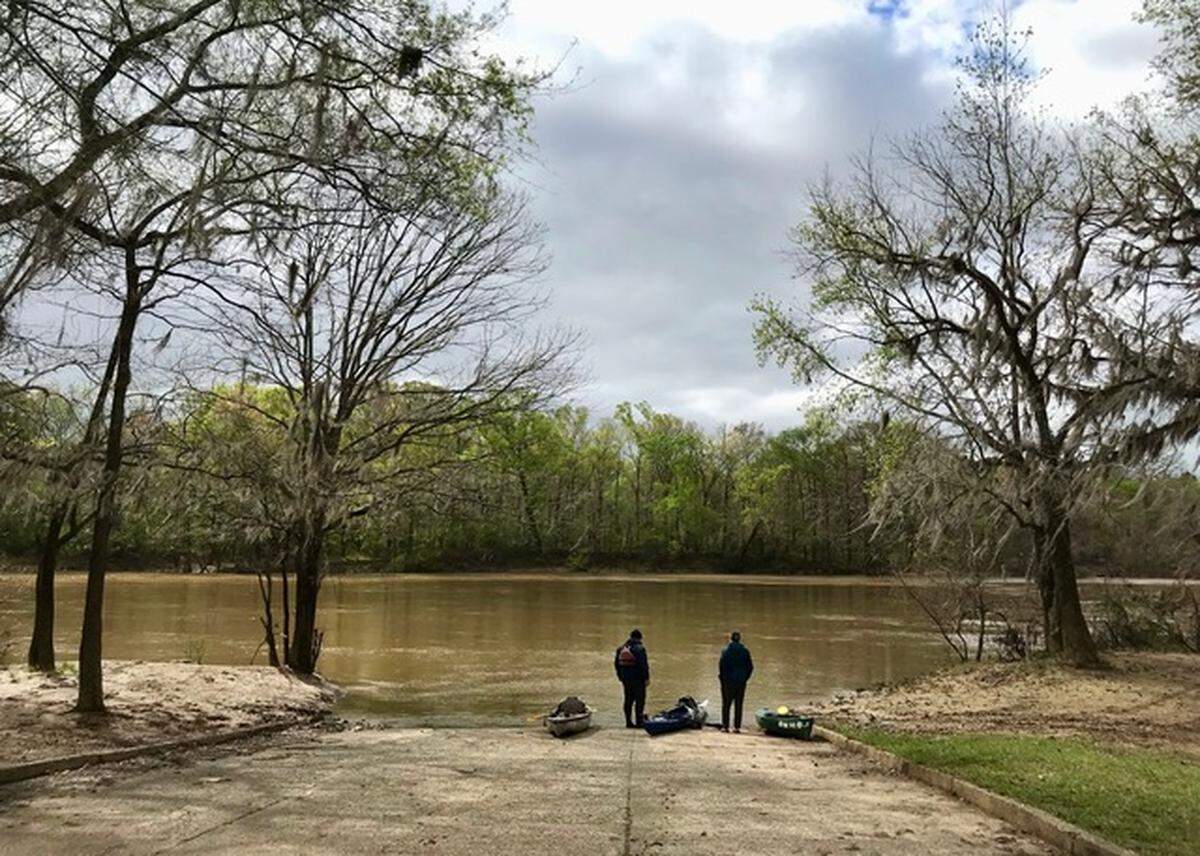 Path to the sea: Kayakers Tim Brown of Savannah and James Brown of Bluffton contemplate the springtime muddy flow of the Oconee River at Bell’s Ferry Landing near Uvalda, Georgia.