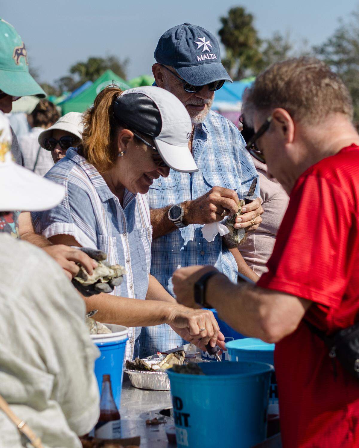 2024 Oyster Festival guests shuck oysters.