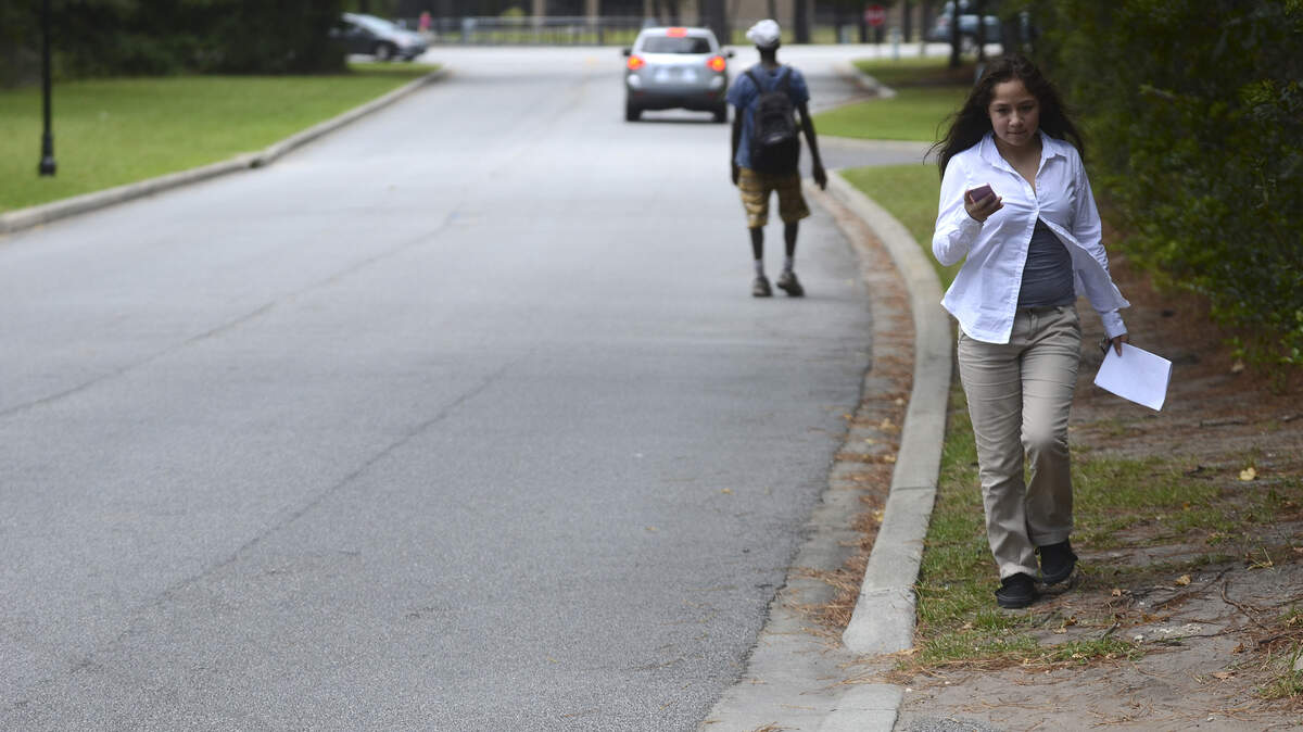 Julie Ponce, 12, a 7th grader at Hilton Head Island Middle School, walks home from school along Main Street the afternoon of Aug. 2, 2014, on Hilton Head Island.