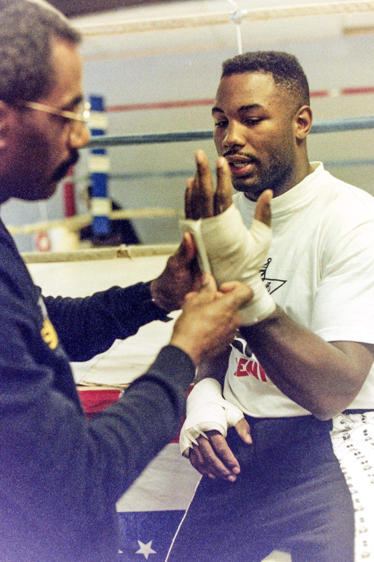 WBC world heavy-weight champ Lennox Lewis, right, gets taped up on March 18, 1993, on Hilton Head Island.