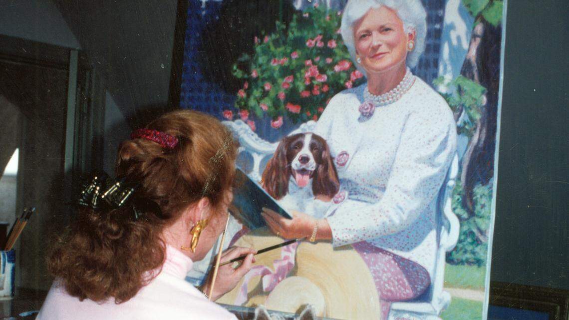Candace Lovely of Hilton Head Island, S.C., holds Mac the dog while painting a portrait of first lady Barbara Bush and her dog, Millie.