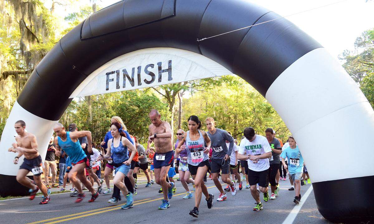 Runners pass under the inflatable start/finish line archway over Beach City Road in 2014 as the Hilton Head Island Historic Mitchelville 5K run/walk got underway. The race route ran through Barker Field, on Mitchelville Beach and through Fish Haul Creek Park.