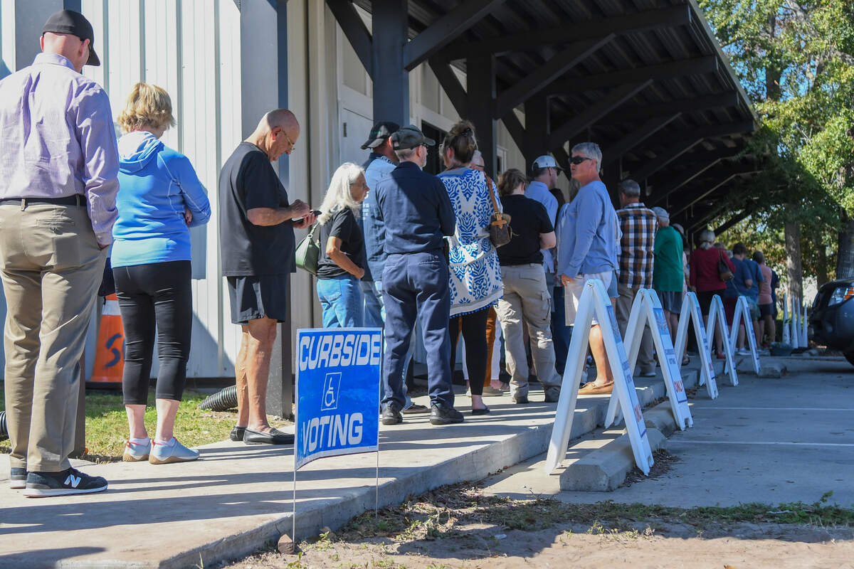 Voters stand in line for early voting at the Board of Voter Registration and Elections of Beaufort County photographed on Oct. 24, 2024 on John Galt Rd. in Beaufort. Estimated to take an hour to cast a vote for the November 2024 presidential election for those voters standing, curbside voting was busy but had numerous open spaces.