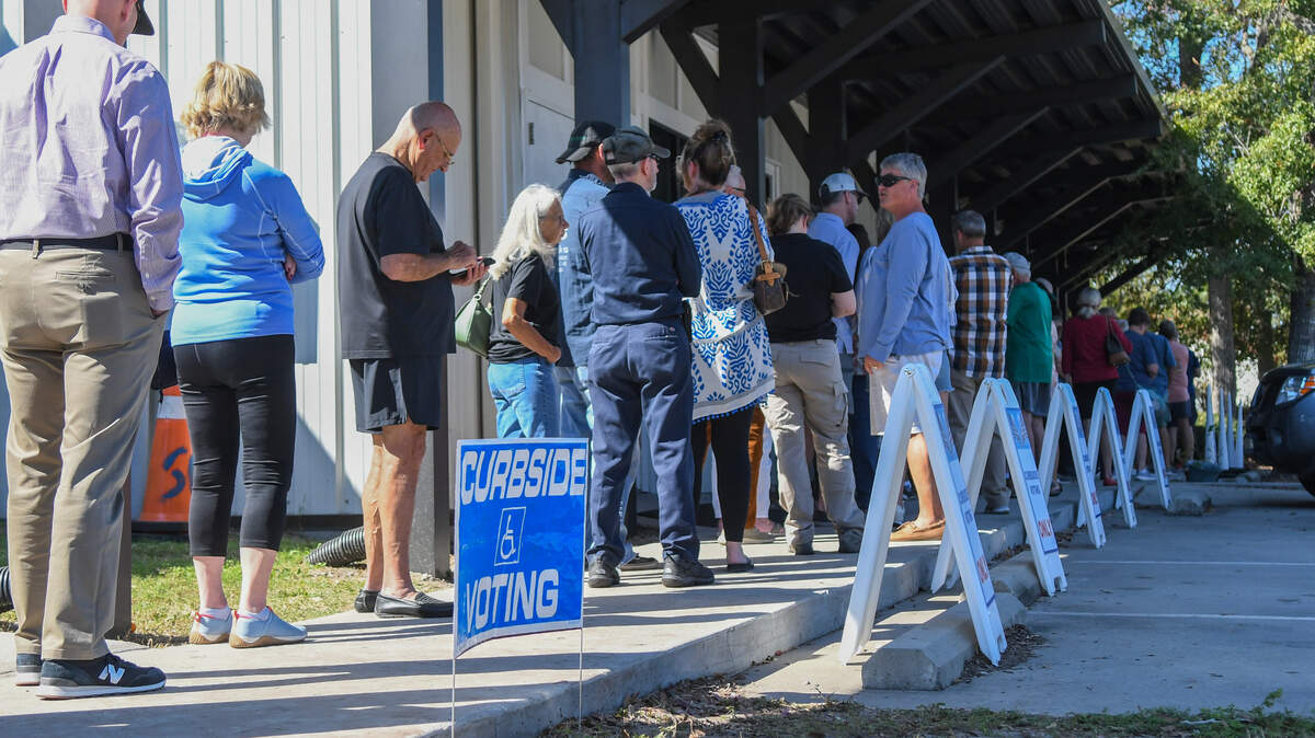 Voters stand in line for early voting at the Board of Voter Registration and Elections of Beaufort County photographed on Oct. 24, 2024 on John Galt Rd. in Beaufort. Estimated to take an hour to cast a vote for the November 2024 presidential election for those voters standing, curbside voting was busy but had numerous open spaces.