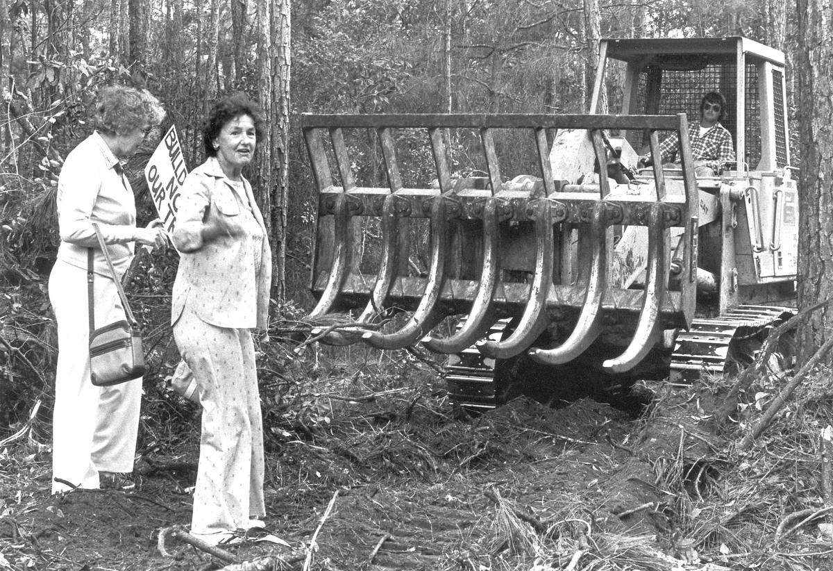 Katie Callahan, left, and Jane Swift stand in front of a bulldozer clearing land off Palmetto Bay Road during a Save Our Trees protest on Hilton Head in 1984.