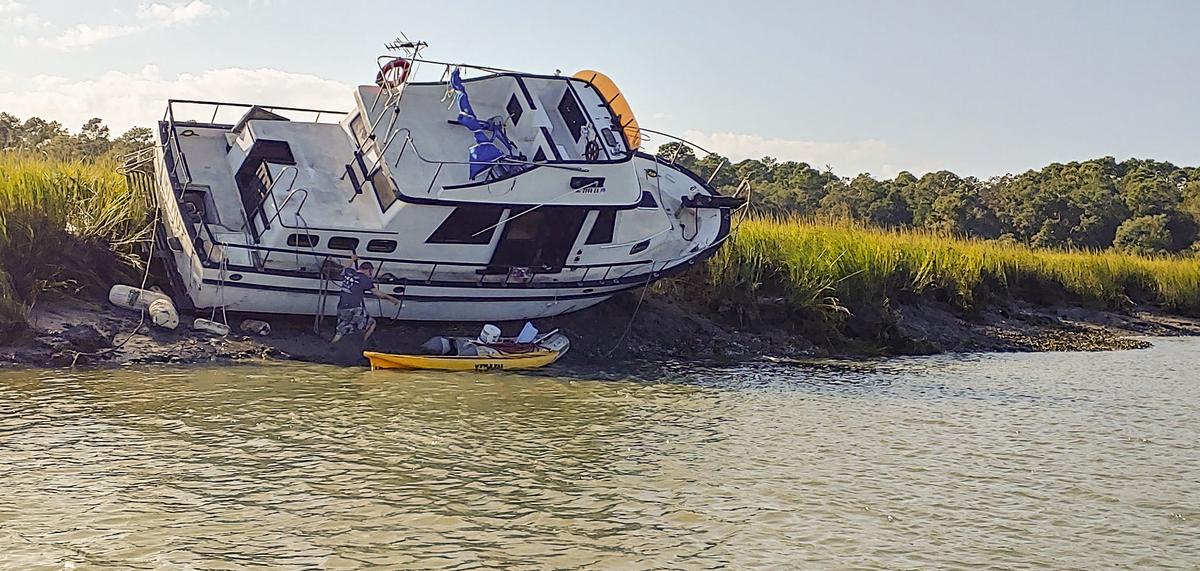 Eric Bollinger’s 34-foot boat “The Tiki Hut” pictured here hard grounded off Hilton Head in the Calibogue Sound. A group of Hilton Head residents have been trying to right the boat since Oct. 17.