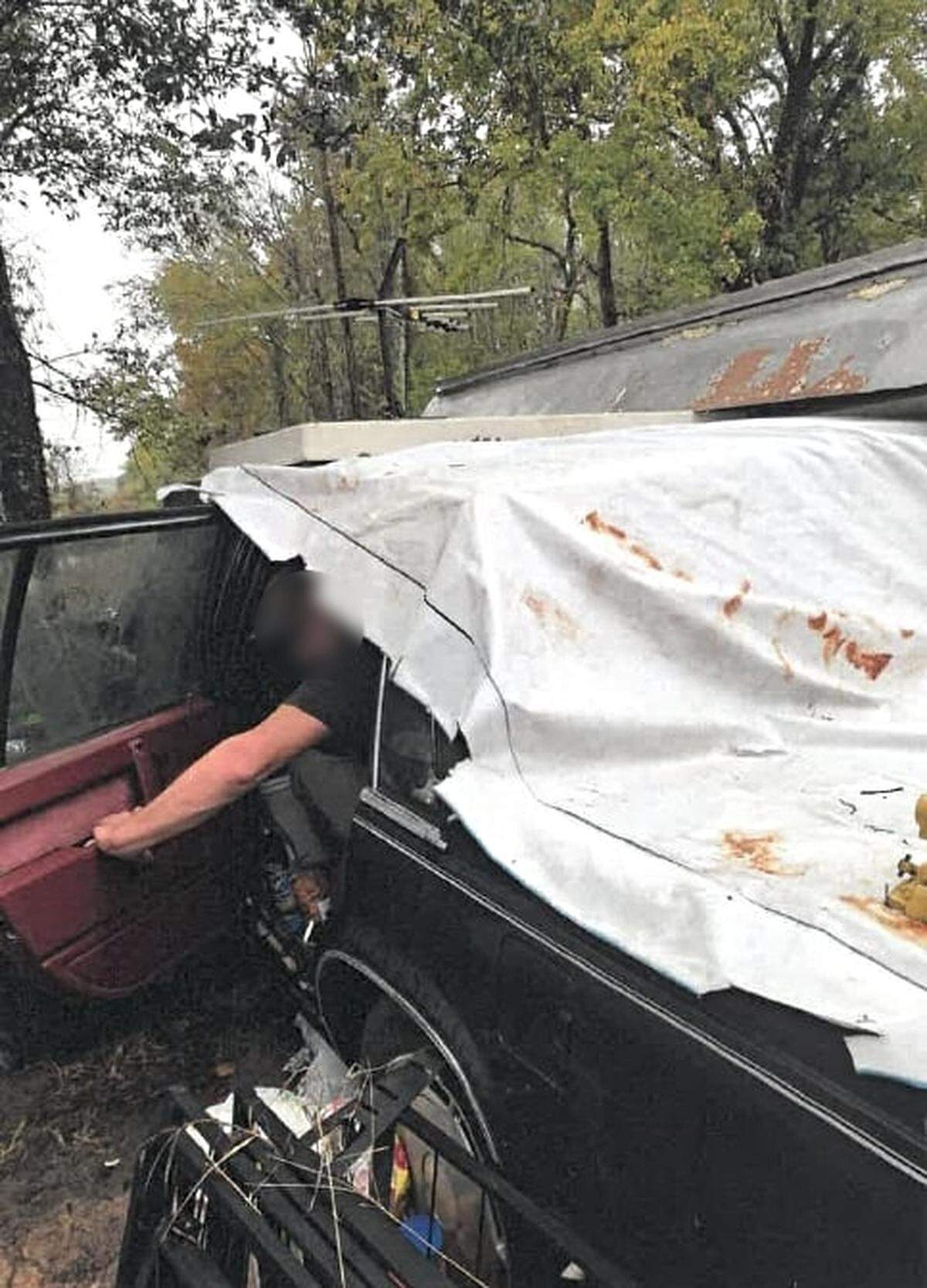 A man opens the door to a car that’s been hollowed out and converted to his home on Reggies Road on Hilton Head Island. He’s paying over $400 in rent to Hilton Head Realtor Tad Segars.