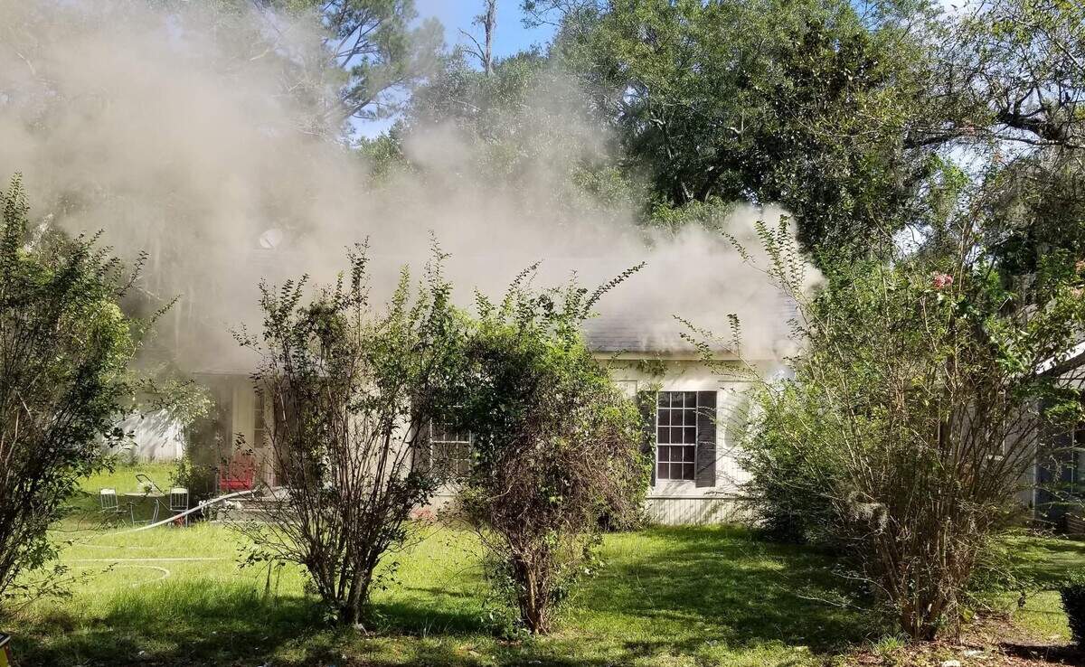 Smoke billows from the home on East Adams Street in Ridgeland on Sunday.
