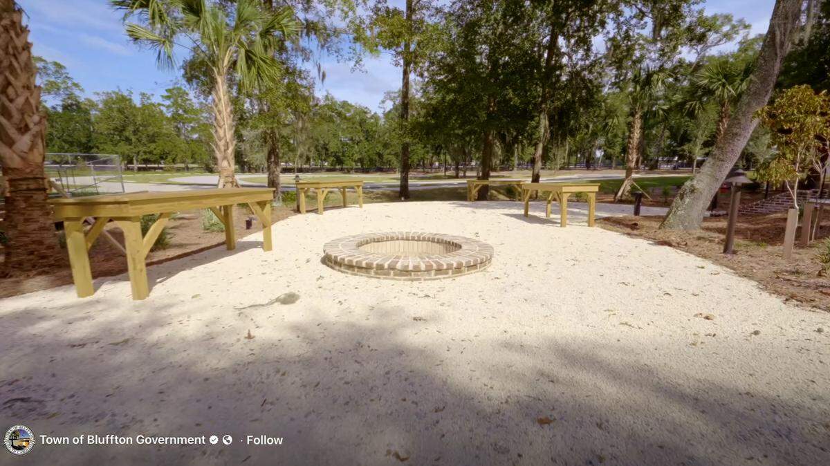 An outdoor fire pit with tables that can be used for shucking oysters are placed outside of the Barn at New Riverside.